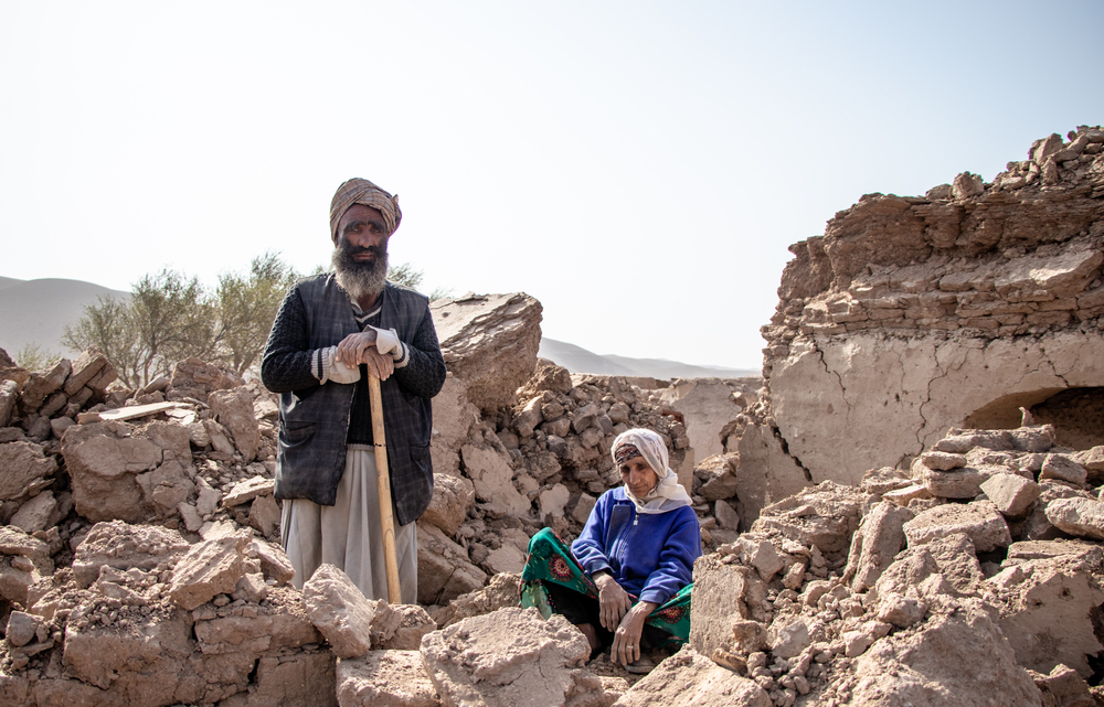 Abdul Salaam and his mother dig through the rubble of what used to be their home in a bid to recover anything they can. Afghanistan, 2023. © Paul Odongo/MSF