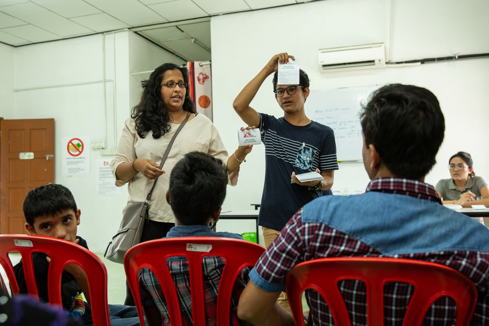 MSF staff do an awareness raising session with patients in the MSF mobile clinic’s waiting area. Bukit Gudung, Penang