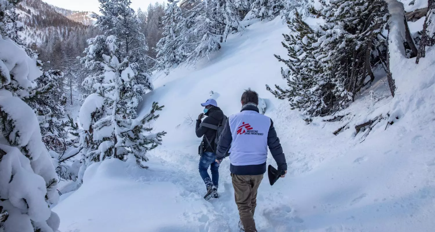 MSF staff walk part of the snow-covered trail in the mountains northwest of Turin, used by people seeking to cross from Italy to France