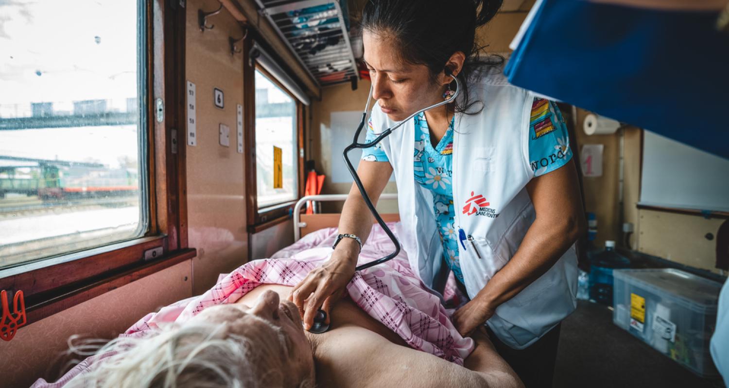 An MSF doctor treats a patient on a hospital train in Ukraine