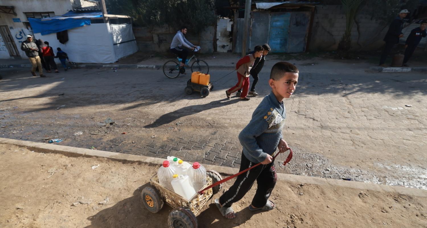 A boy in Gaza carrying water.