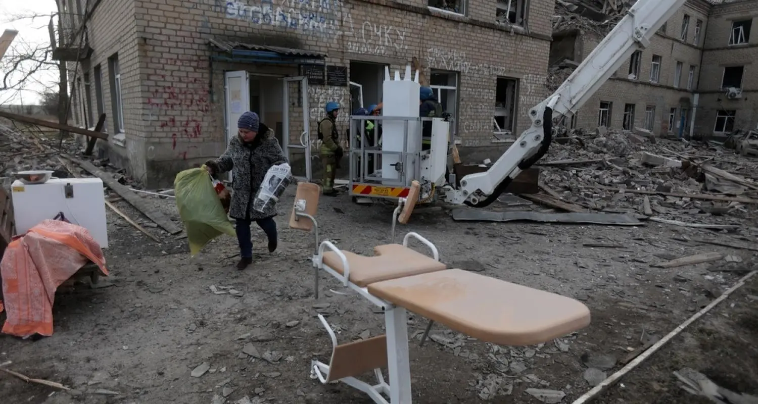 Employees of the State Emergency Service of Ukraine and medical staff evacuate medical equipment from a maternity hospital destroyed by a Russian missile attack in the town of Selydove, Donetsk region