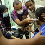 Kairul, a Rohingya man who fell two floors while working at a construction site, is examined by a nurse ahead of his doctor’s appointment at MSF’s clinic in Penang. @Arnaud Finistre