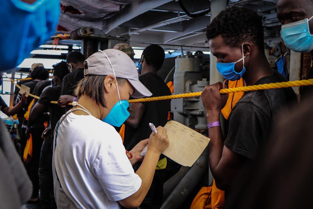 Midwife Marina takes the temperature of people on deck of the Sea-Watch 4. © MSF/Hannah Wallace Bowman