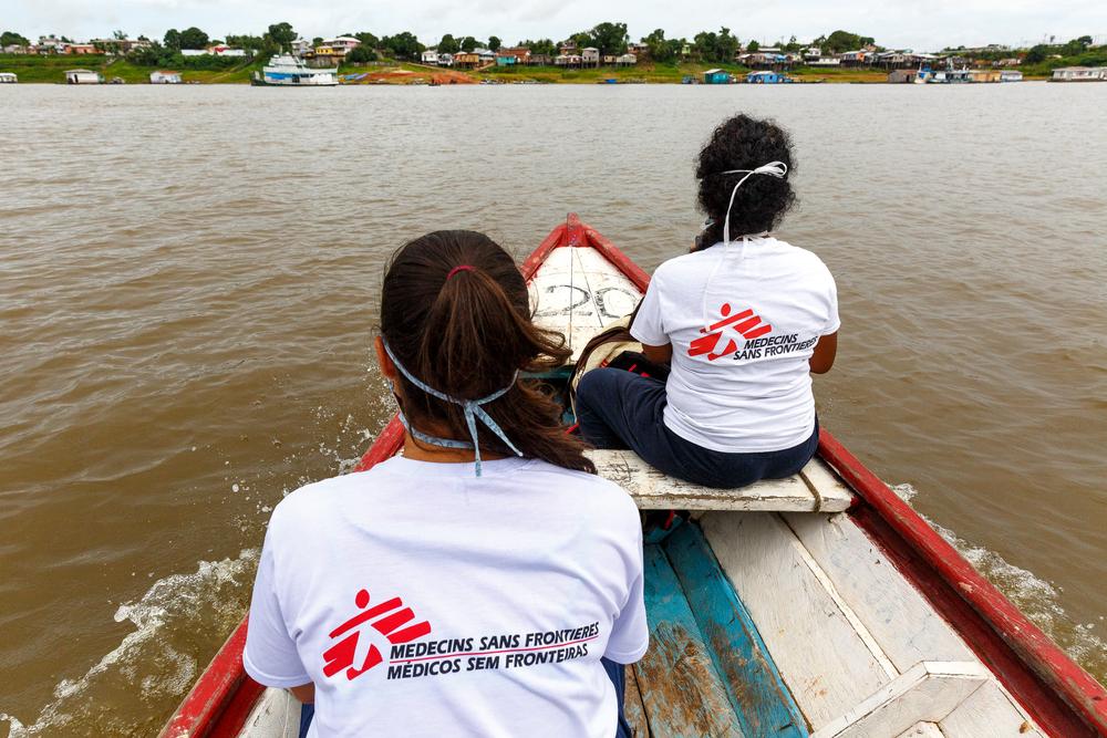 Doctor Ebel Saavedra and health promoter Uliana Esteves cross Lake Tefé by boat for a health promotion activity in the Abial neighborhood of Tefé, in the state of Amazonas, Brazil.  Diego Baravelli