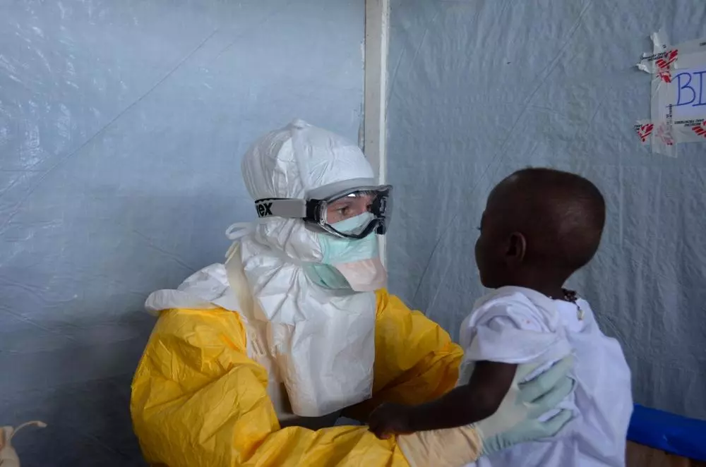 There are many children in the Guéckédou Ebola case management centre. Some are orphans, which makes caring for them more complex. Staff easily become attached to these patients, whom they are the only ones to touch and comfort through two pairs of gloves and a mask. Photo: Julien Rey/MSF