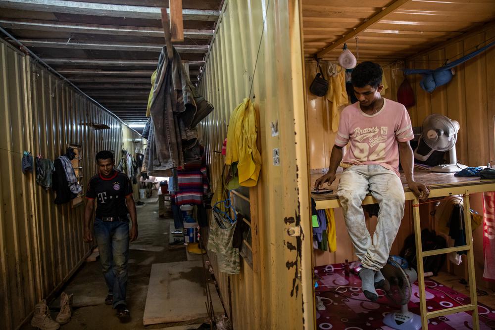 Nur, 27 years old (right), shares this container with seven other Rohingya workers employed on a massive construction site. Muhammad (left) shares the container with Nur. Penang @Arnaud Finistre