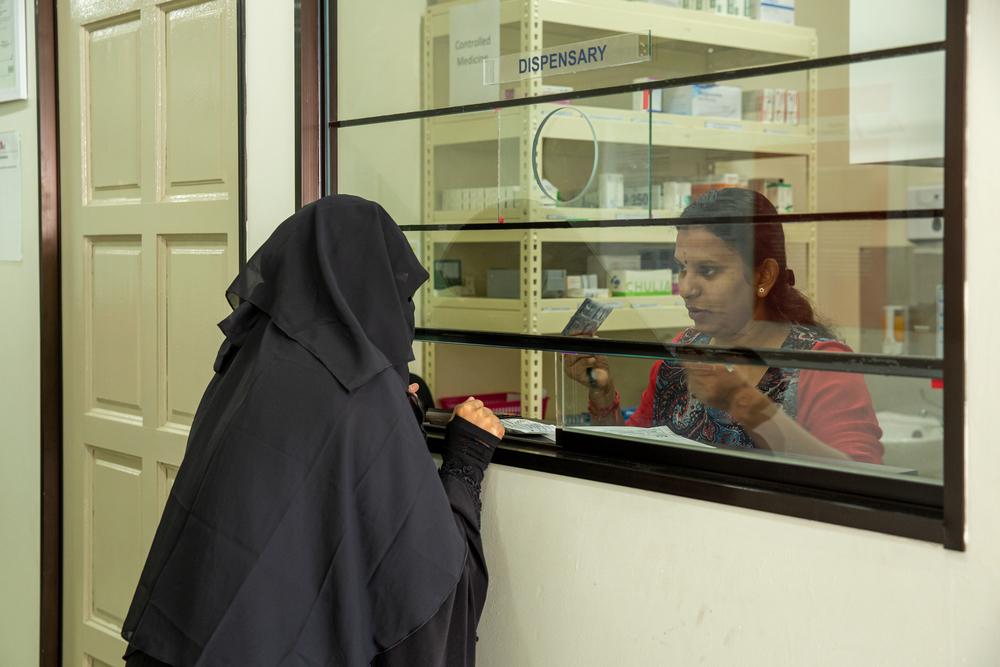 Vithya, head of pharmacy at the Doctors Without Borders/Médecins Sans Frontières (MSF) clinic in Penang, explains how to take a prescription to a patient’s wife. Penang