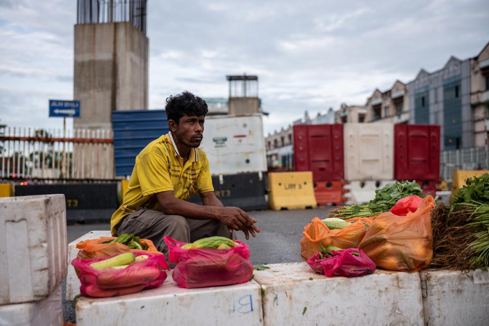 A Rohingya man sells vegetables near the Pasar Baru market, Kuala Lumpur. @Arnaud Finistre