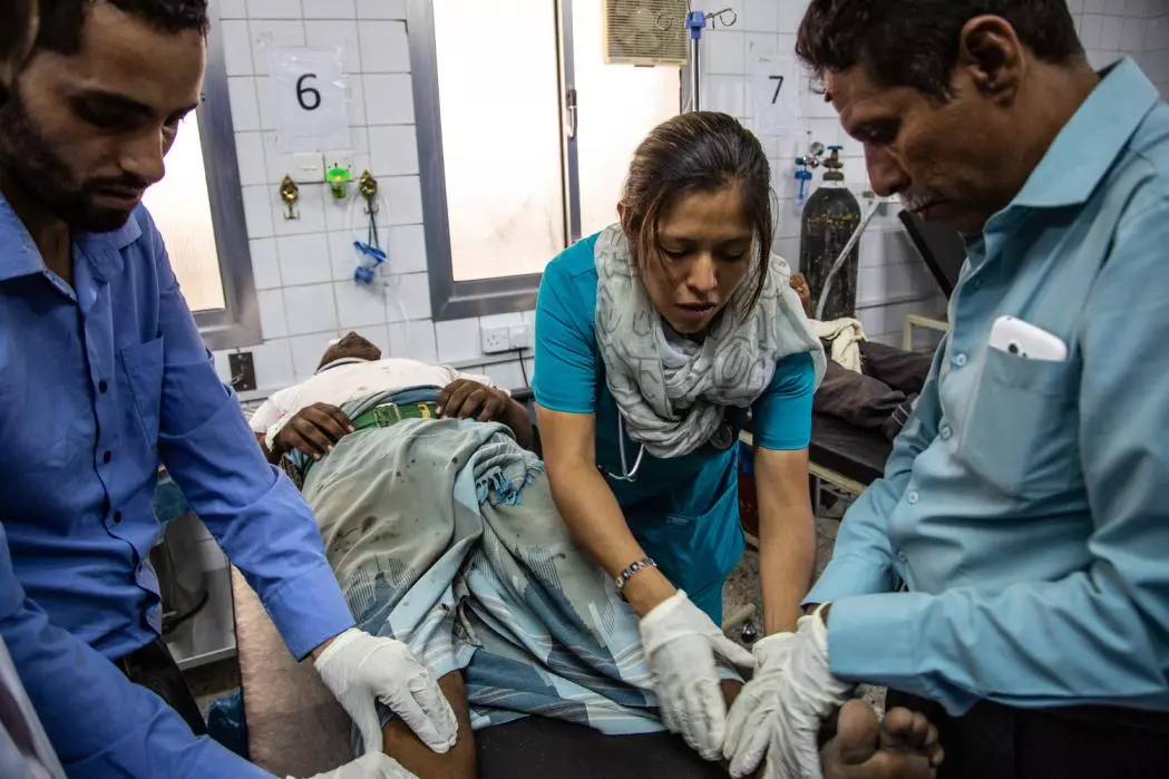 An ER doctor is examining a patient injured during a road traffic accident