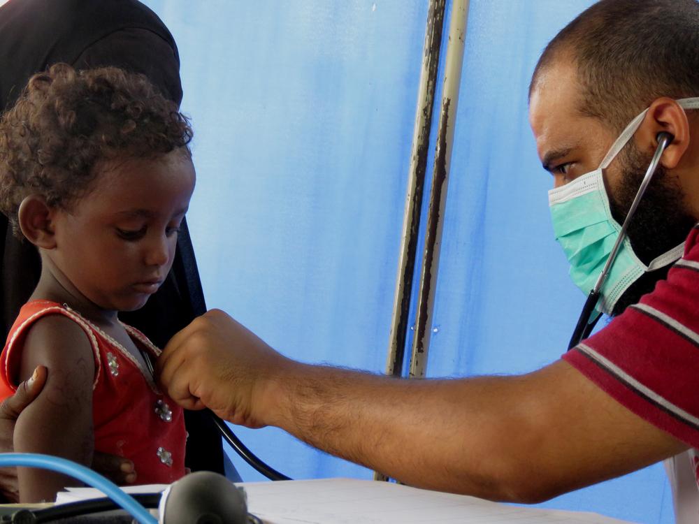 MSF doctor Naseer Abdulkarim checks a child suffering respiratory problems
