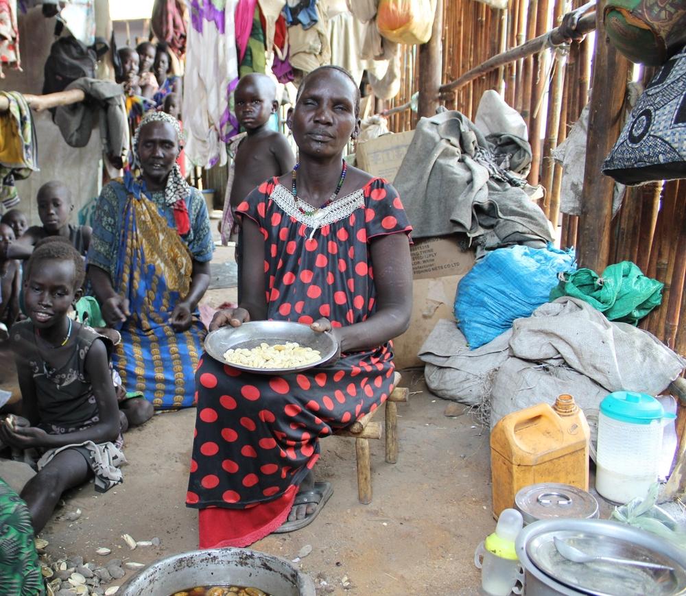 45-year old Nyachuol* prepares a meal of forest fruits for her children. *Name changed