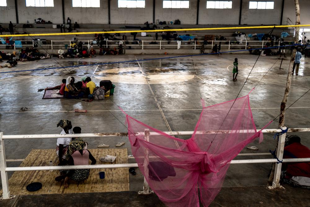 People sit inside a stadium which has been converted to a reception centre for internally displaced people fleeing the armed conflict which has been taking place in Mozambique's Cabo Delgado province.  © Tadeu Andre/MSF