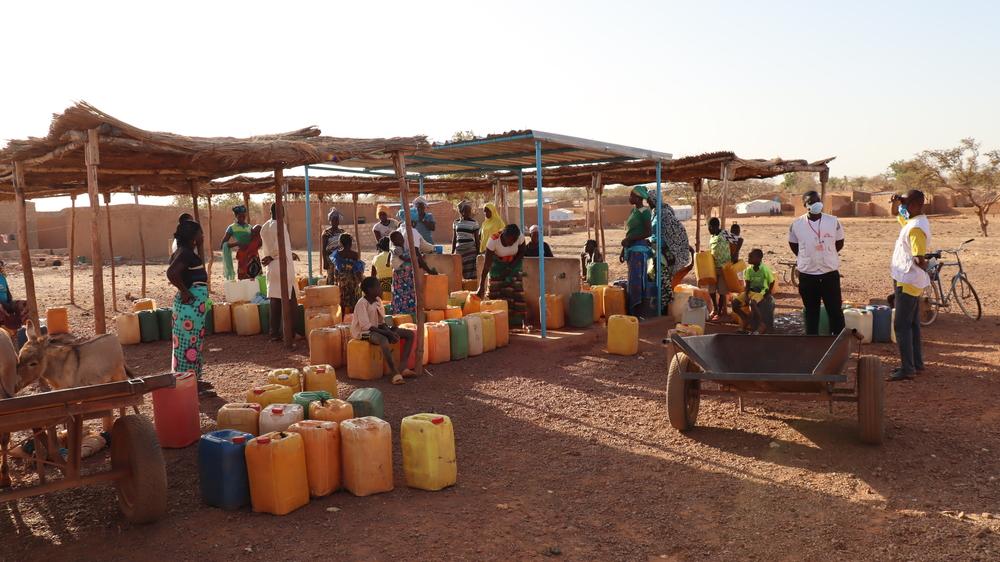 Women and children filling their jerry cans with clean water at a newly rehabilitated borehole in the town in Titao in Burkina Faso’s North region.