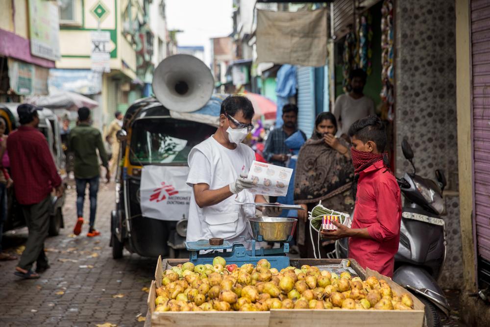 Giving masks and soaps to street hawkers. Mumbai, India.