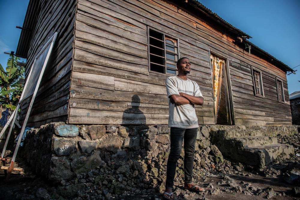 Antoine Ngola Syntexe outside the house of the family that hosted him in Sake, DRC.