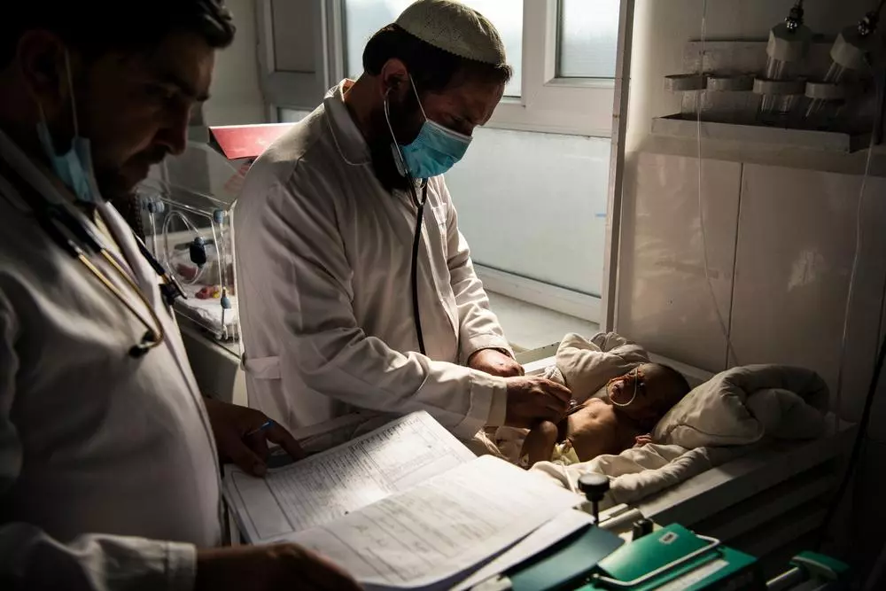 Dr Daud, head of paediatrics, and paediatrician Dr Asadullah Mal examine a patient in the neonatal intensive care unit (NICU) at Boost Hospital, Helmand's primary provincial hospital in the capital Lashkar Gah. 