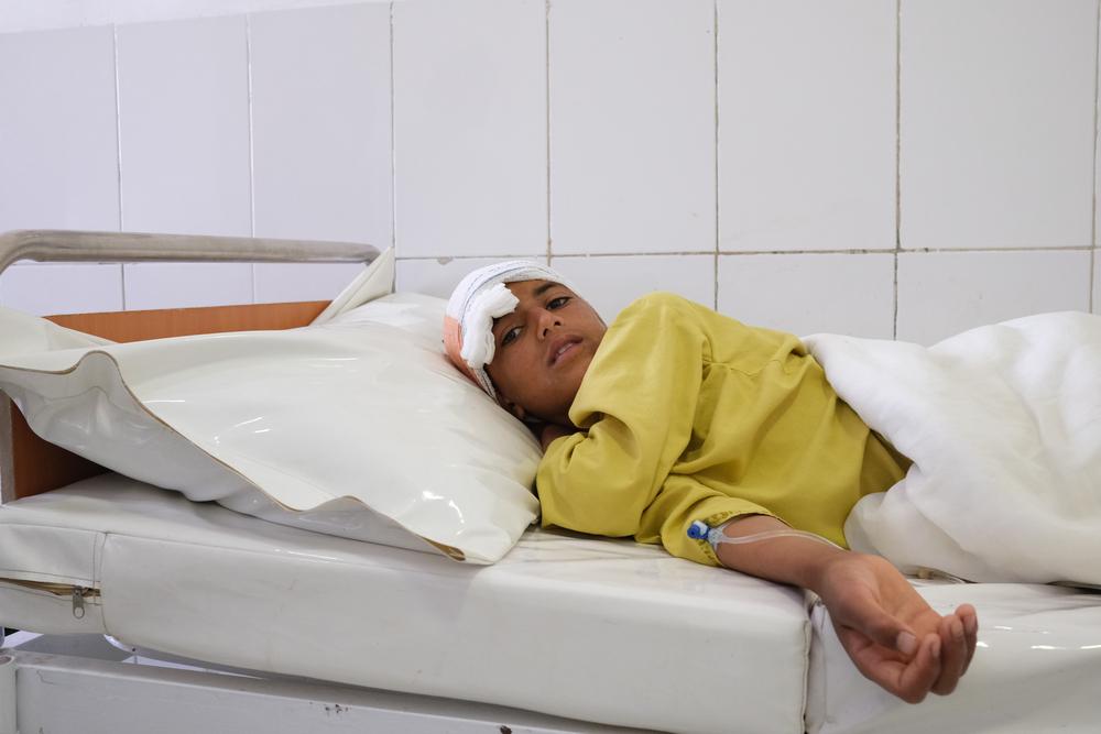 Samiullah, 12 years old, suffered a gunshot wound to the head on 4 May. His family had to cross gardens and a river, travelling for two and a half hours to avoid fighting before reaching Boost hospital.