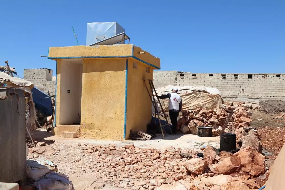 An MSF staff member checks a latrine built by MSF teams in a camp in northwest Syria. Syria, 2021. © Abdurzaq Alshami 