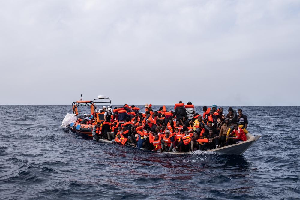 On November 16, the MSF rescue team from the Geo Barents reaches the small wooden boat that's taking on water, to rescue the people on board. On the right side, Moustafa and his sons are waiting patiently to receive a life jacket.