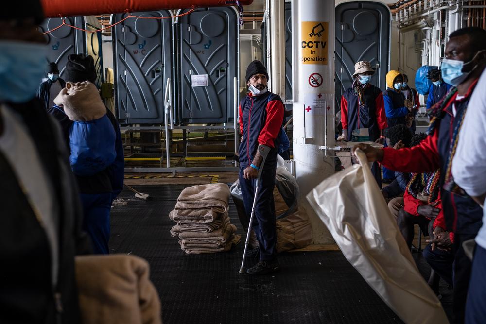 After MSF teams announced that they were assigned a port of safety in Messina, Sicily, survivors started to clean and tidy up Geo Barents' deck. Moustafa wasn't able to help due to his handicap.