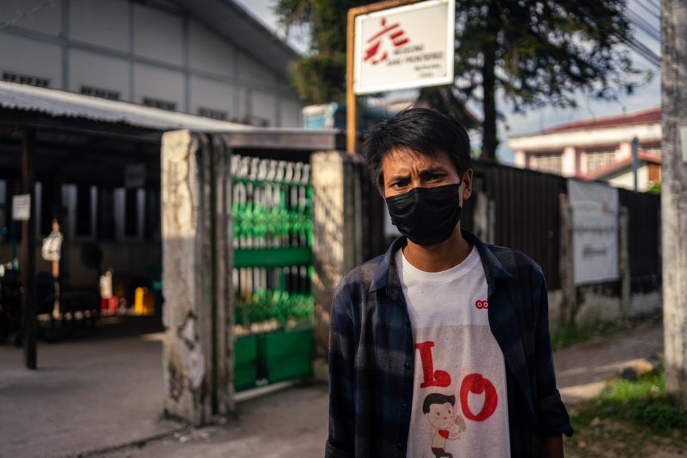 Brang Seng, 30, who was diagnosed with HIV in April 2021, stands outside MSF’s Myitkyina clinic in Kachin state. Myanmar, 2021. © Ben Small/MSF