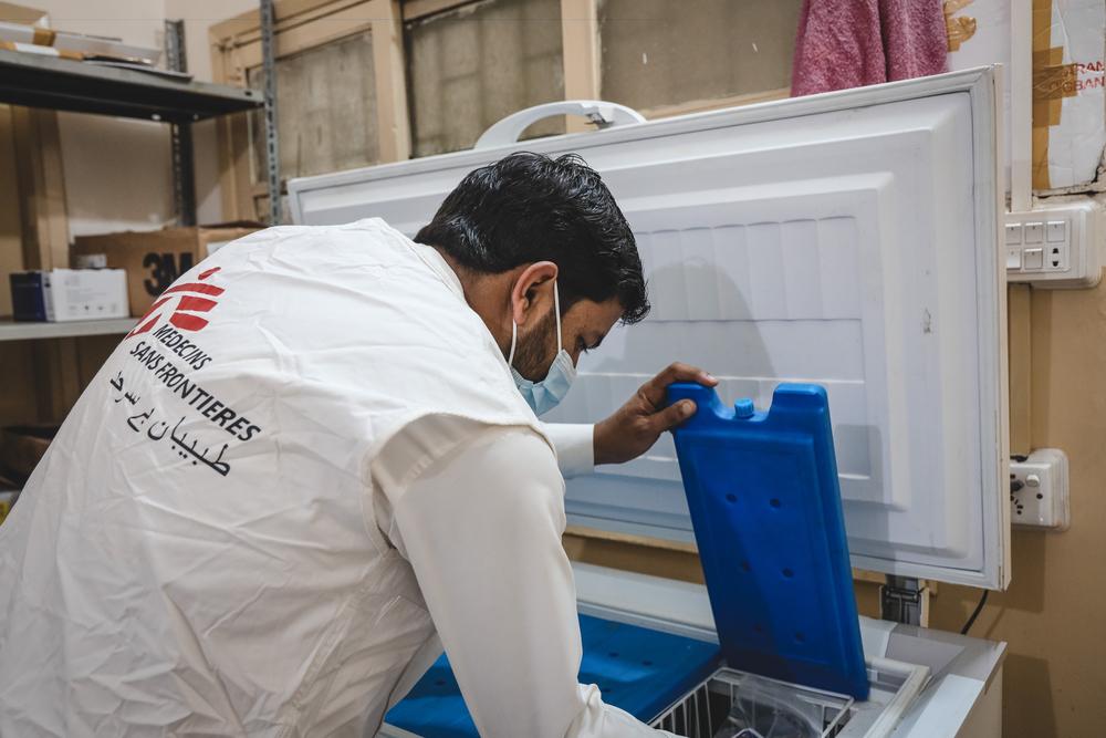 Zahid Iqbal manages the temperature of the COVID-19 vaccination cold chain at the Sher Shah rural health centre, Karachi.
