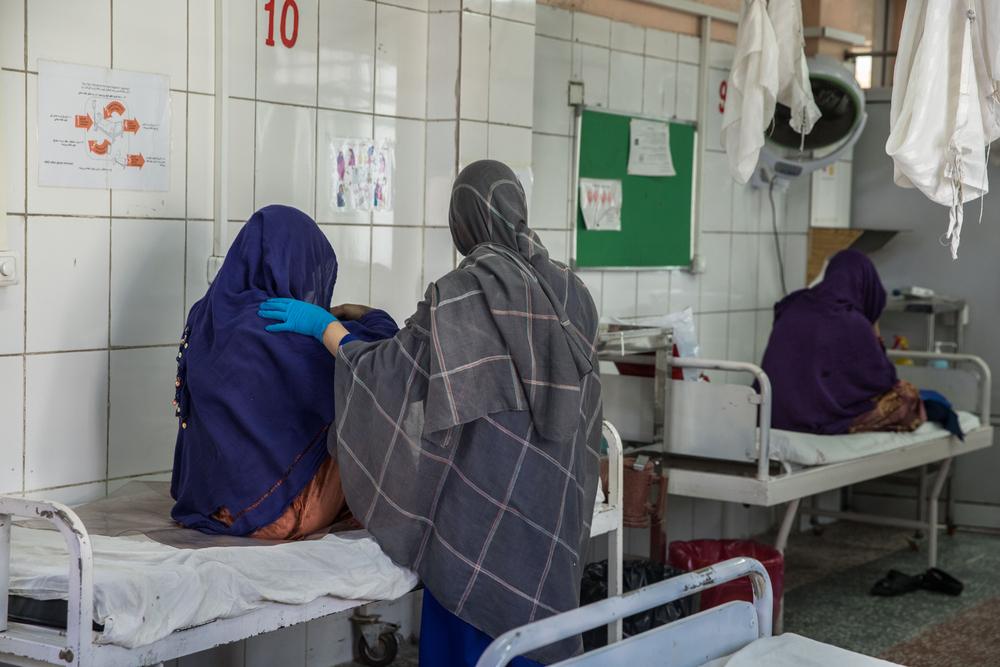 An MSF midwife accompanies a pregnant woman in the labor room at the MSF Khost maternity hospital. 