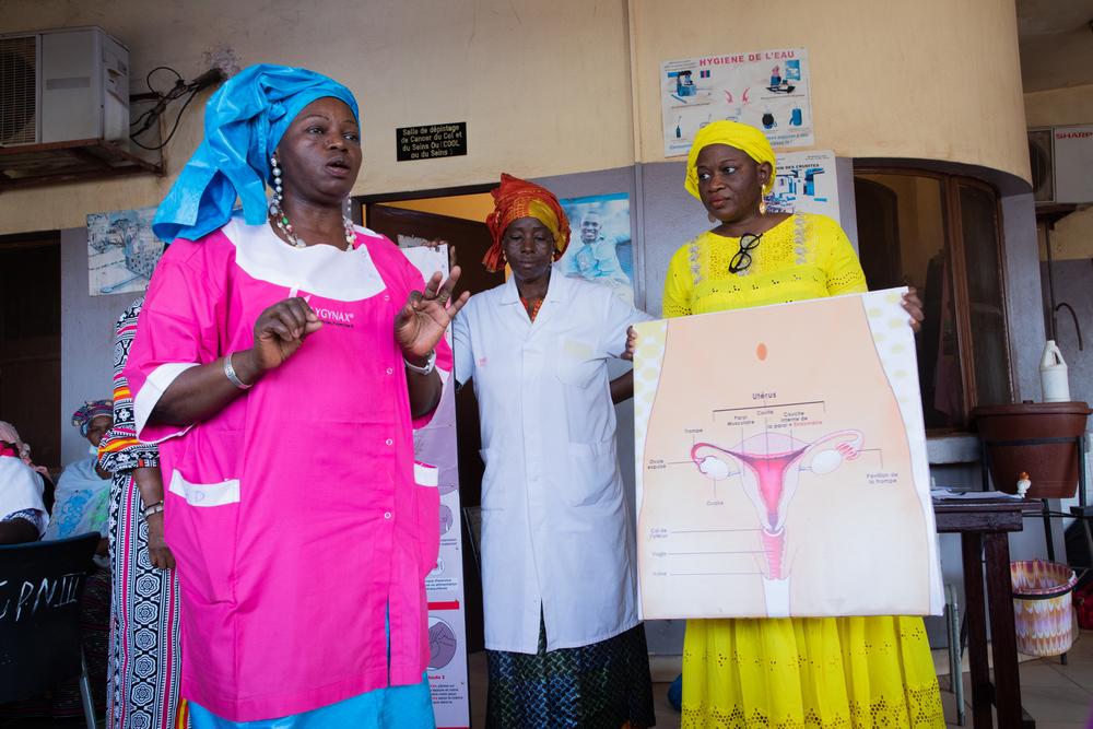 Dr Mama Sy Konaké (on the left with a pink coat), head doctor of commune VI district in Bamako, with other medical colleagues doing health promotion on breast and cervix cancer prevention at the referral health centre of the commune VI.
