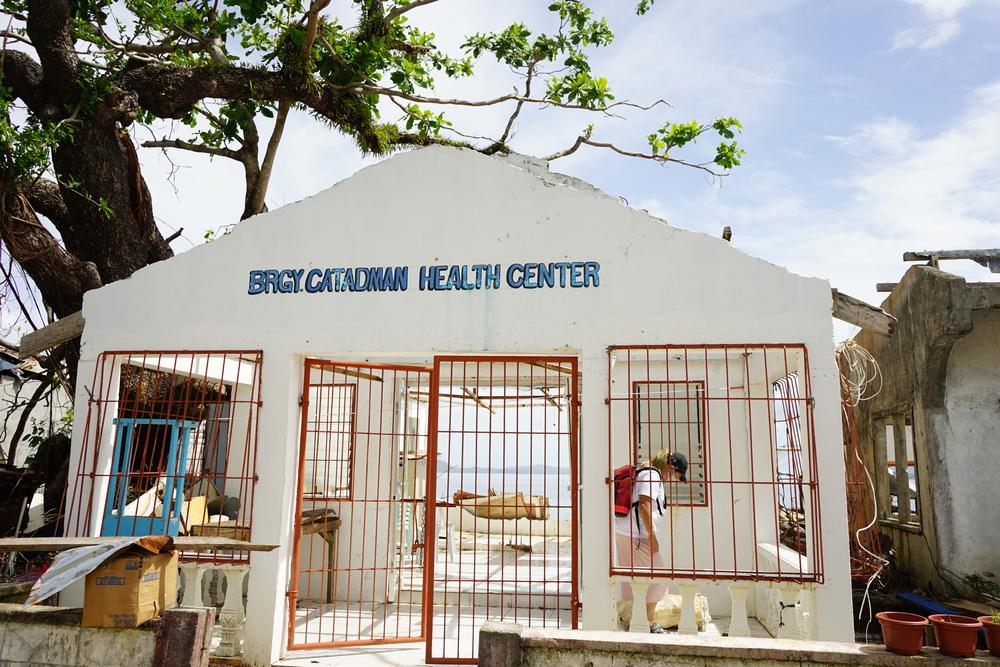 All that remains of the barangay health center are a few walls, a rusty weighing scale and a damaged examination bed. The roof was blown away by Typhoon Rai (local name Odette)