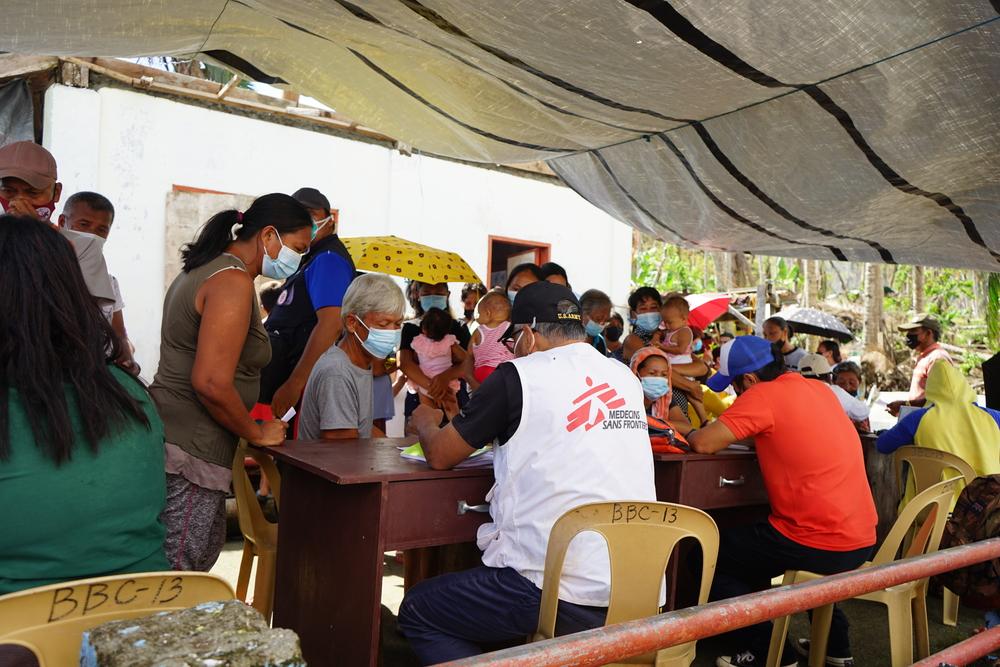 While the hygiene kits are being distributed, some villagers line up at the mobile clinic to consult with Dr. Raul Salvador, Medical Team Leader.
