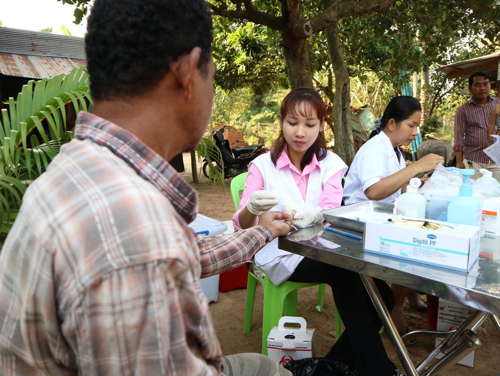 The nurses Prak Vichhuta and Ty Chhunnly test blood samples of villagers for Hepatitis C during an active case finding campaign in a village in Moung Ruessei district.