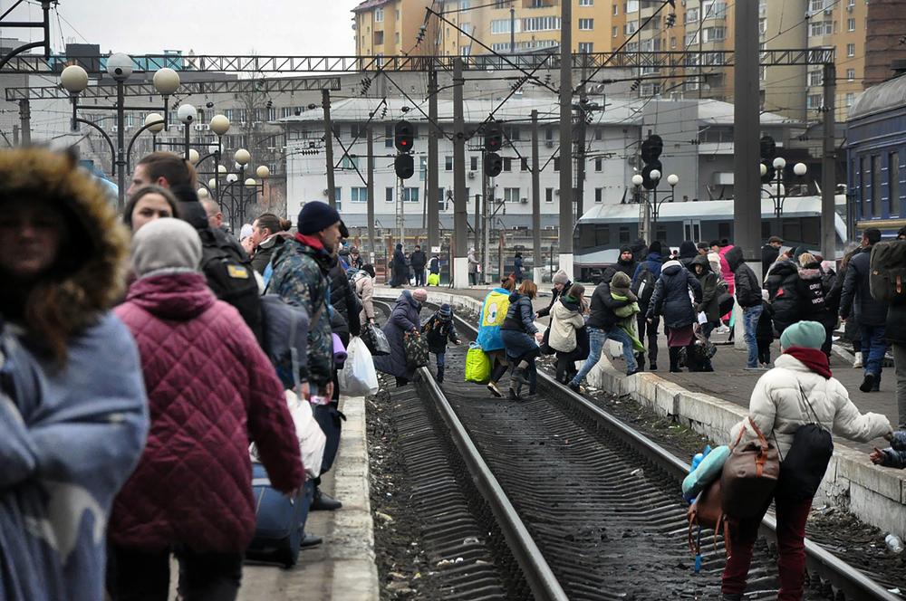 Hundreds of people trying to escape the on-going conflict in Ukraine wait for a train to Poland at the central train station in Lviv. 
