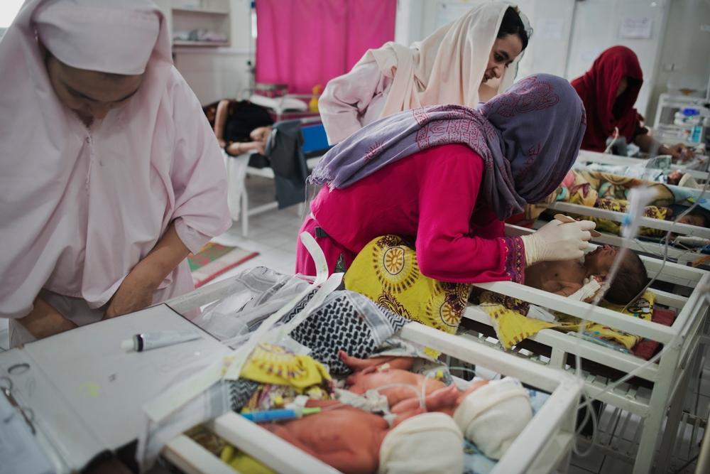 A newborn is examined by Pediatric Nurse Isabelle Arnould and midwives in the neonatal ward of the MSF Maternity Hospital in Khost, Afghanistan. 