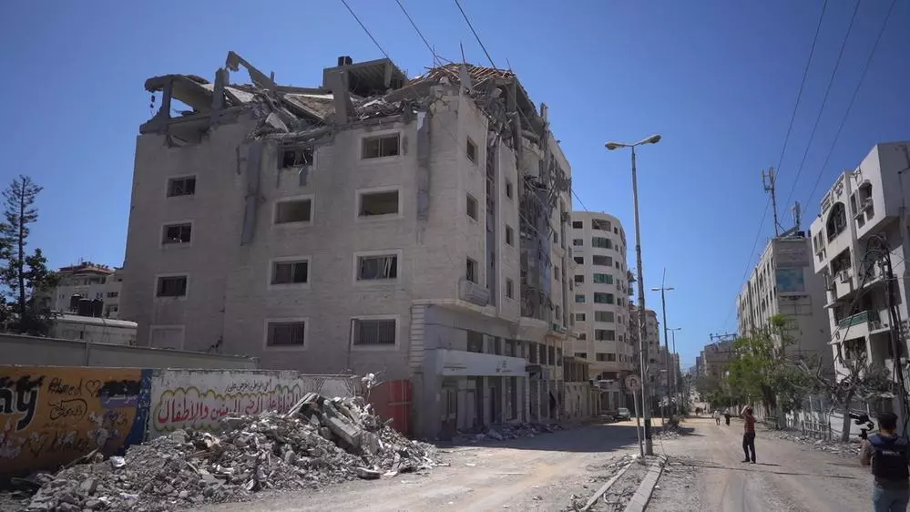 Palestinian walks amidst the rubble in the Gaza city.