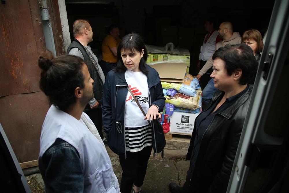 MSF logistician and translator talk with village council secretary of Holovanivsk, central Ukraine