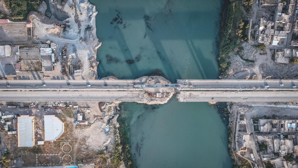 An aerial view of the partially functioning fifth bridge, once known as the city’s biggest bridge, near the remnants of the historic Qera Serai Castle (The Black Palace).