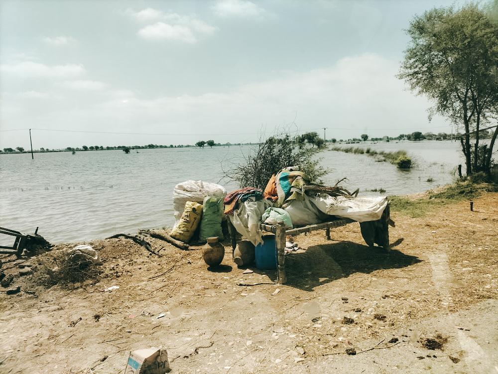 A view of a village in Dera Murad Jamali administration where flood-water is stagnant and people have moved to the side of roads in flood-hit eastern Balochistan.