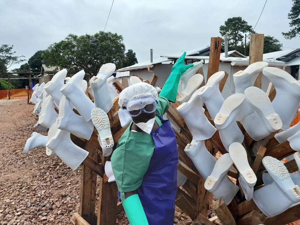 Hygienist is hanging the boots to dry after being decontaminated by hygienists at Mubende Ebola Treatment Center.