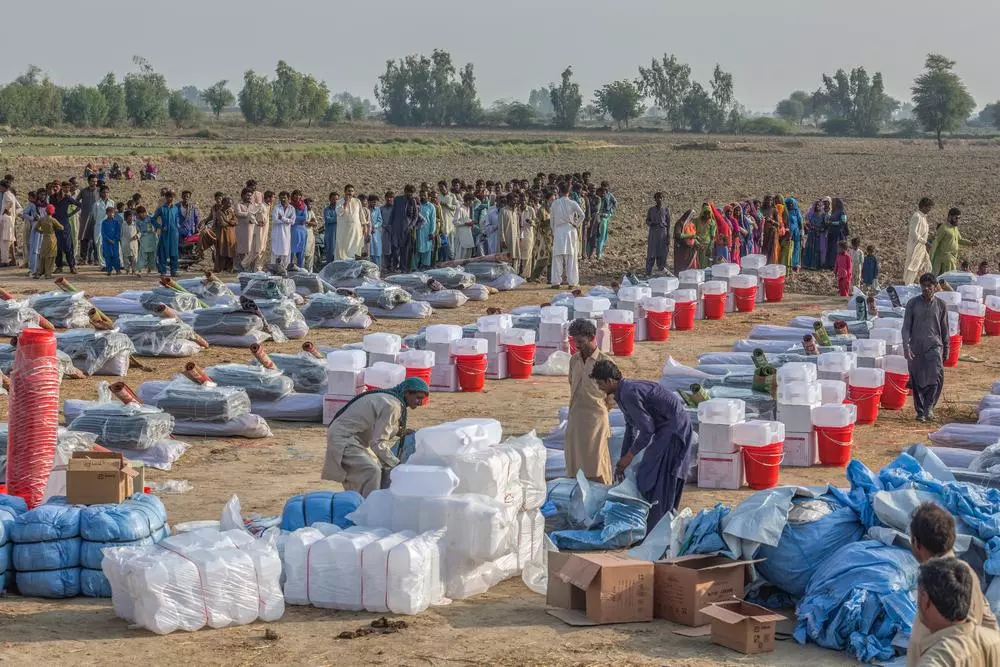 MSF staff and volunteers arranges Non Food Items (NFIs) kits for distribution