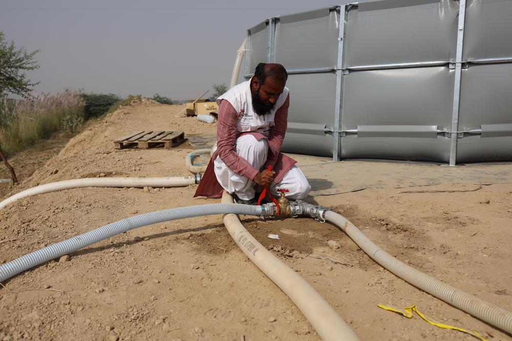 An MSF’s Water and Sanitation Specialist – Umer is checking the water pipe fixings of the water filtration plant installed by MSF in district Jaffarabad, Eastern Balochistan.