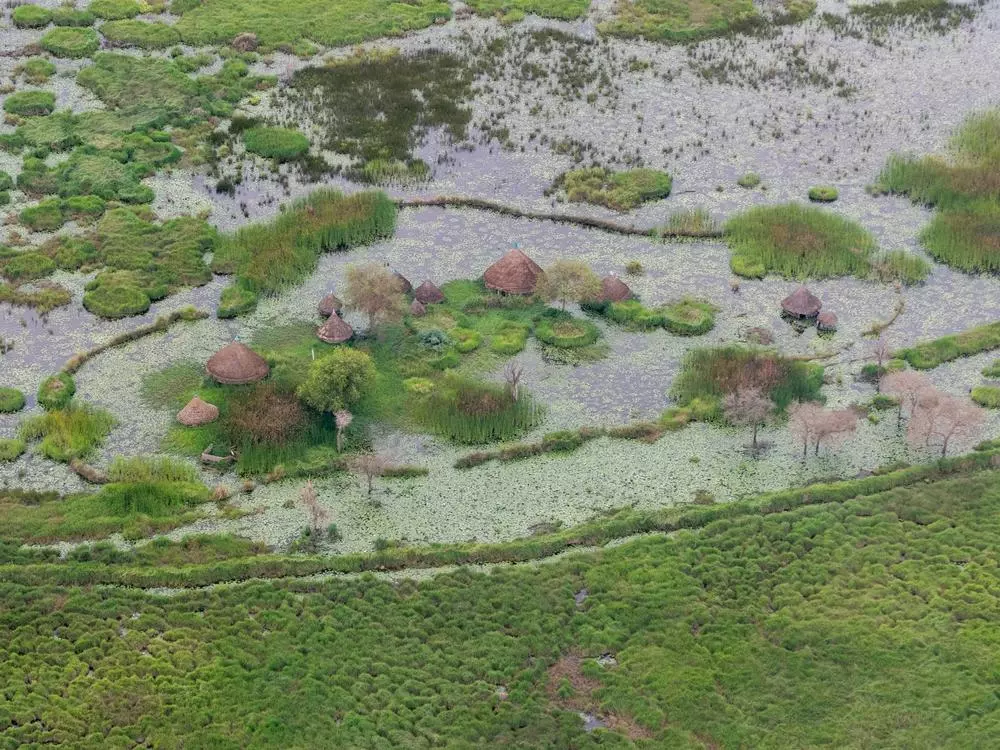 Aerial view of a flooded village near Old Fangak, South Sudan. The fourth year of consecutive flooding has devastated the area. South Sudan, 2022. © Florence Miettaux