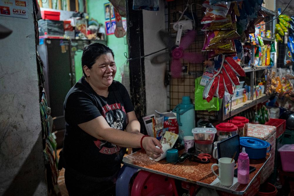 Amalia, a former Doctors Without Borders patient, runs a small store in front of her home in the Smokey Mountain neighborhood. Philippines, 2023. © Ezra Acayan
