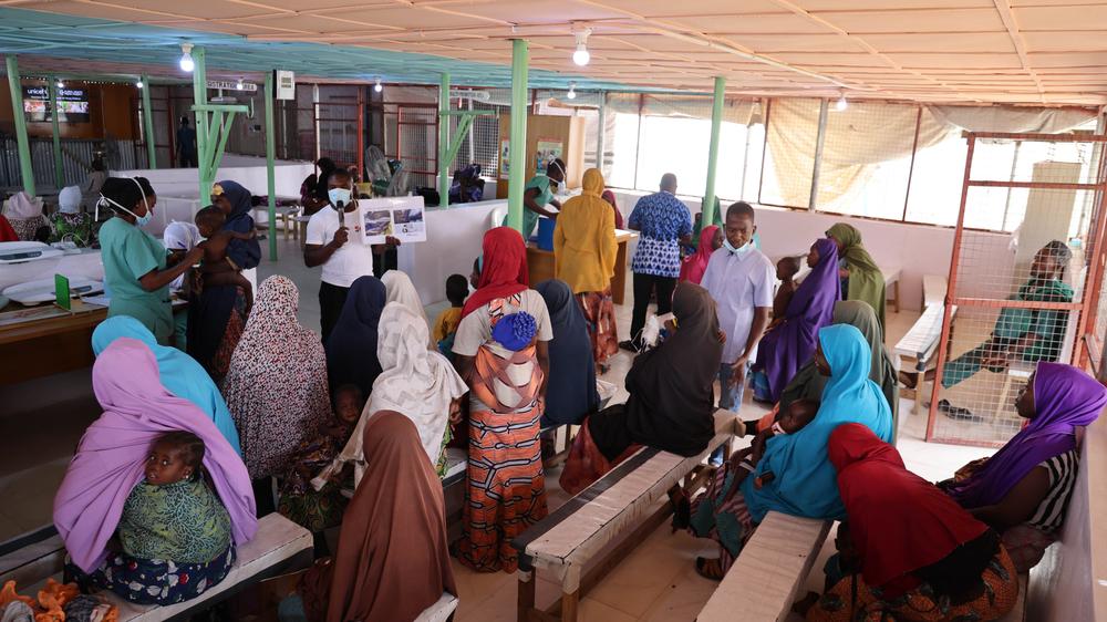 Waiting to be attended to at the triage, the women listen to an Doctors Without Borders staff about good health seeking practices. Nigeria, April 2023.