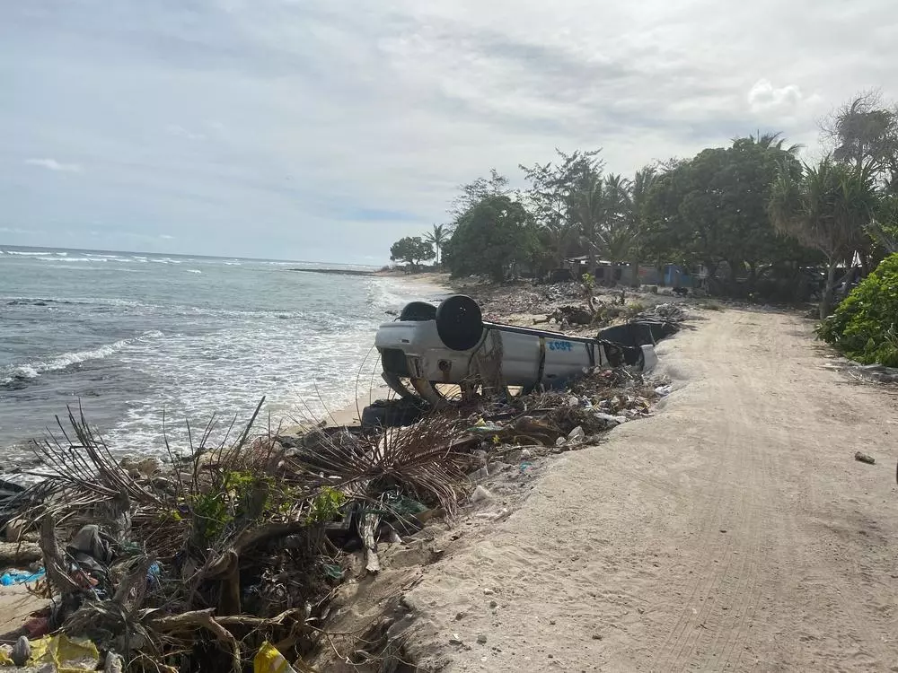 On a beach in a village in South Tarawa, the piles of rubbish littering the beach are everywhere. Locals have constructed barriers (built out of rubbish, tyres and sometimes cars) to protect the banks from sea surges and king tides. Kiribati, March 2023. © MSF/Nicolette Jackson