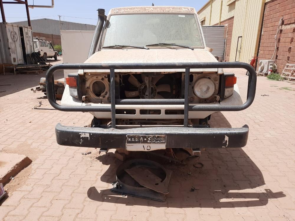 Doctors Without Borders vehicles stripped of its tires after the warehouse in Khartoum was looted and occupied by armed men. Sudan, May 2023. © MSF