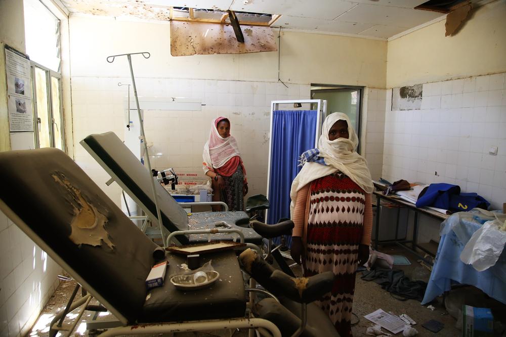 Two women survey the damage to the delivery room of the health centre in Sebeya town, in the northern Ethiopian region of Tigray. Ethiopia, March 2021. © Igor Barbero/MSF