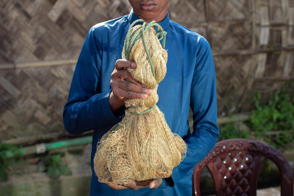 I believed it would be useful here in Bangladesh," remarks Abdulshakour, as his son displays the fishing net he once used. As a fisherman in Myanmar, selling his catch at local markets. 