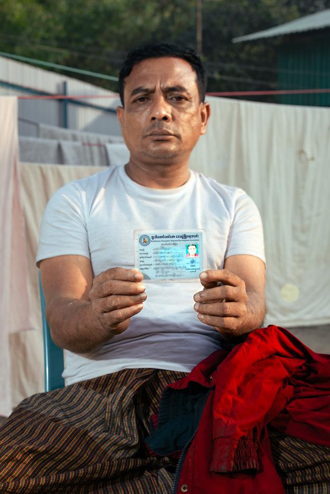 Habibullah, 52, holds up his driver's license. In Myanmar, he earned a living as a driver, transporting passengers from place to place. "I brought the documents to prove our origins, thinking they might ask for them," he says.