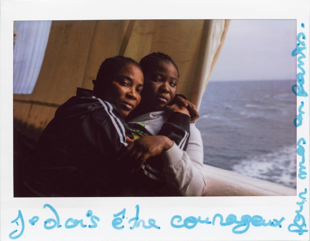 A polaroid photo of Bintou (left) is inscribed, ‘Je dois être courageuse pour mes enfants’ (I have to be brave for my children’). Bintou, from Côte d’Ivoire, was among the survivors rescued from the Central Mediterranean Sea by MSF’s search and rescue boat Geo Barents. Central Mediterranean, December 2022. © Mahka Eslami
